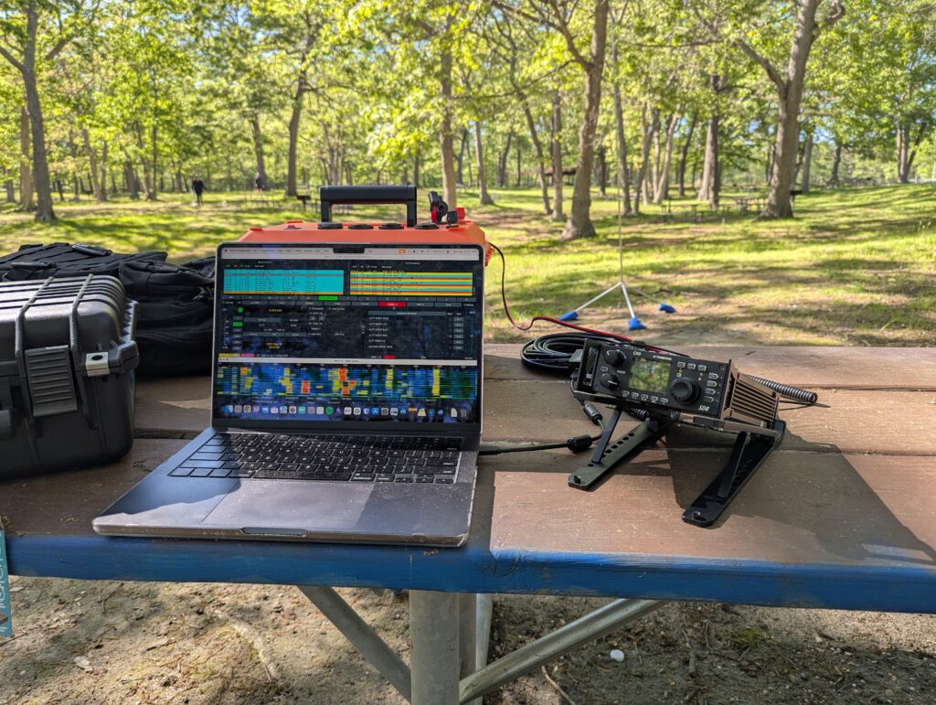 Portable ham radio gear at Bethpage State Park on picnic table with forest backdrop